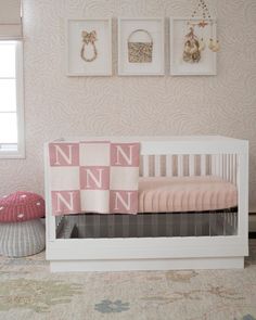 a baby's room with pink and white decor