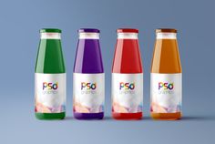 four bottles of juice with different colors on them