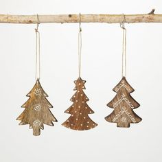 three wooden christmas trees hanging from a branch