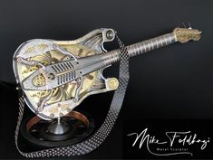 a metal guitar sculpture sitting on top of a black table