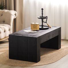 a black coffee table with a candle on it