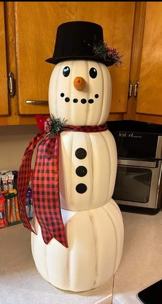 a snowman made out of plastic sitting on top of a kitchen counter