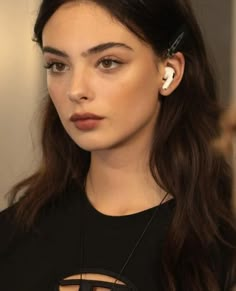 a woman with ear buds on her ears