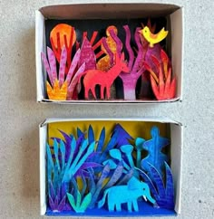 two boxes filled with different colored paper animals