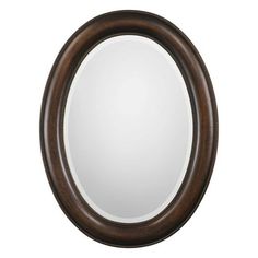 an oval mirror on a white background with a brown frame and beading around the edge