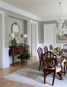 a dining room table with chairs and a chandelier