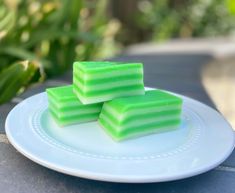 three pieces of green soap sitting on top of a white plate