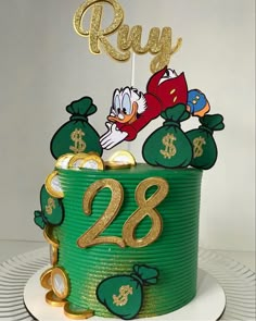 a birthday cake decorated with money bags and donald duck