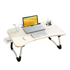 a laptop computer sitting on top of a wooden desk next to a keyboard and mouse