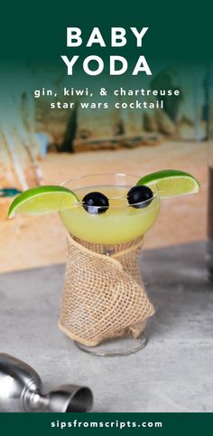 baby yoda cocktail in a glass with lime and olive garnish