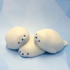 two white plastic animals laying on top of each other