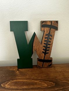 the letter y is made out of wood and has a football design on it's side