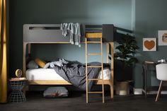 a bedroom with a bunk bed, desk and chair