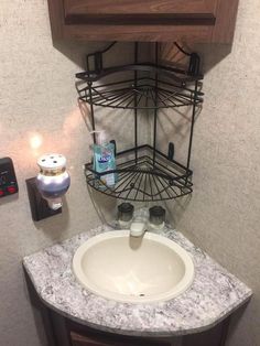 a small bathroom with a sink and toiletries on the counter top in front of it