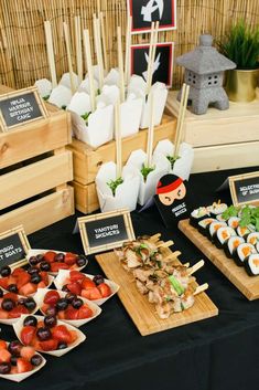 an assortment of sushi and other foods are on display at a party or gathering