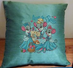 a pillow with two mice on it and the words love to sew in blue