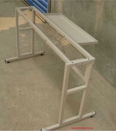 a white desk sitting on top of a cement floor