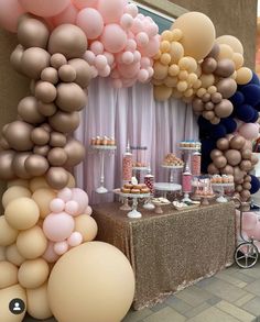 a table topped with lots of balloons and desserts