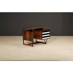 a small wooden desk with two drawers on one side and a striped drawer on the other