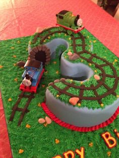 a birthday cake that is shaped like a train