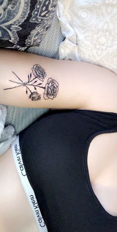 a woman's arm with flowers on it and the words, love is in the air