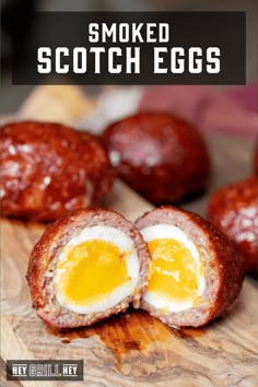 an egg is cut in half on a cutting board with the words smoked scotch eggs