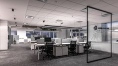 an empty office with glass walls and desks