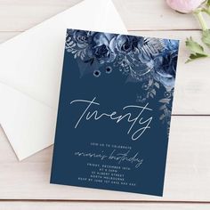 a blue floral birthday party card with the words twenty on it and an envelope next to it