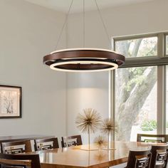 a dining room table and chairs in front of a large window