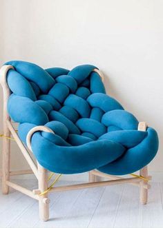 a blue couch sitting on top of a wooden frame