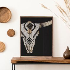 a cow skull is mounted on the wall above a shelf