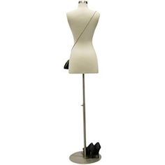 a white mannequin is standing on a metal base with a black shoe holder