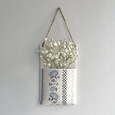 a hanging bag with flowers in it on the wall