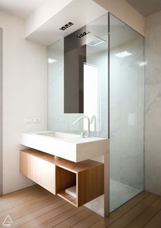 a bathroom with a sink, mirror and shower stall is shown in this image from the inside