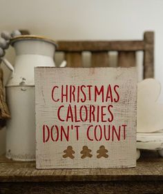 a wooden sign that says christmas calories don't count on it next to other items