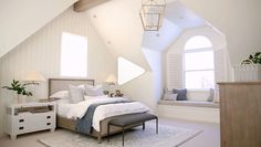 a bedroom with white walls and vaulted ceilings