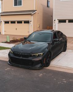 a black car parked in front of a house