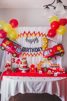 a birthday party with firetrucks and balloons