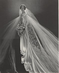 an old black and white photo of a woman in a wedding dress