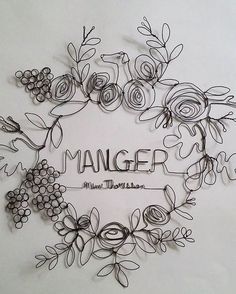 the word manager is surrounded by flowers and vines on a white background with black lettering