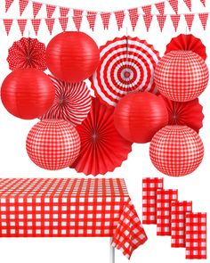 a bunch of red and white paper decorations on a table with checkered cloths