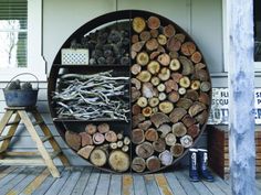 there are many logs stacked on top of each other in front of the door and behind it is a shelf with several different types of wood