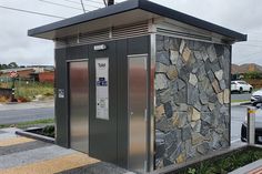 an outdoor toilet on the side of the road