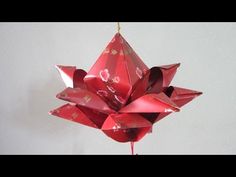 a red origami decoration hanging from a string