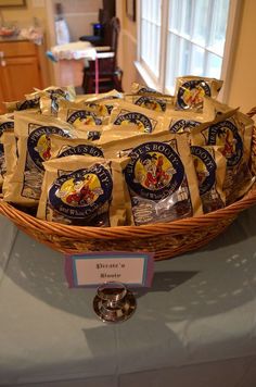 a basket filled with lots of cheese sitting on top of a blue tablecloth covered table