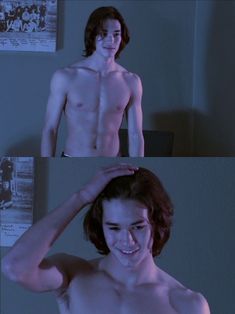 the shirtless young man is smiling and touching his hair