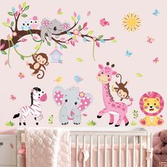 a baby's room with pink walls and wall decals