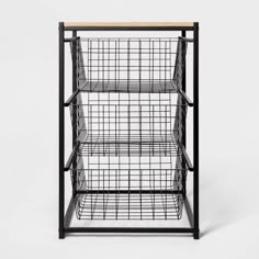 a black metal shelf with wire baskets on top