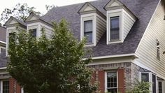 a large house with many windows in the front yard