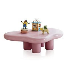 a pink table with an animal figurine sitting on it's top and two small toys at the base